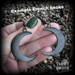 Featuring large black enamel crescent moons, these stunning crescent moon earrings measure just under 7cms from tip to tip and are nice and light weight at approx 5 grams each.

This pair has been made with french hooks, for pierced ears.
