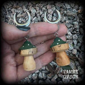This pair of earrings features gorgeous forest green wood mushrooms, nice and light weight at 8 grams a piece, and nice and dangly at just on 7cms.

This pair has been made on 5/8” gauge (16mm) surgical steel cradles, suitable for stretched lobes.


