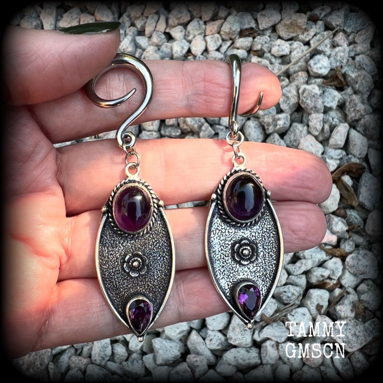 Featuring beautiful purple amethyst gemstones in a boho antique silver setting , this pair of earrings weighs approx 8 grams a piece and measure just under 8cms from tip to tip.

This pair have been made on 6 gauge (4mm) surgical steel full curl hooks, to be worn in stretched lobes.