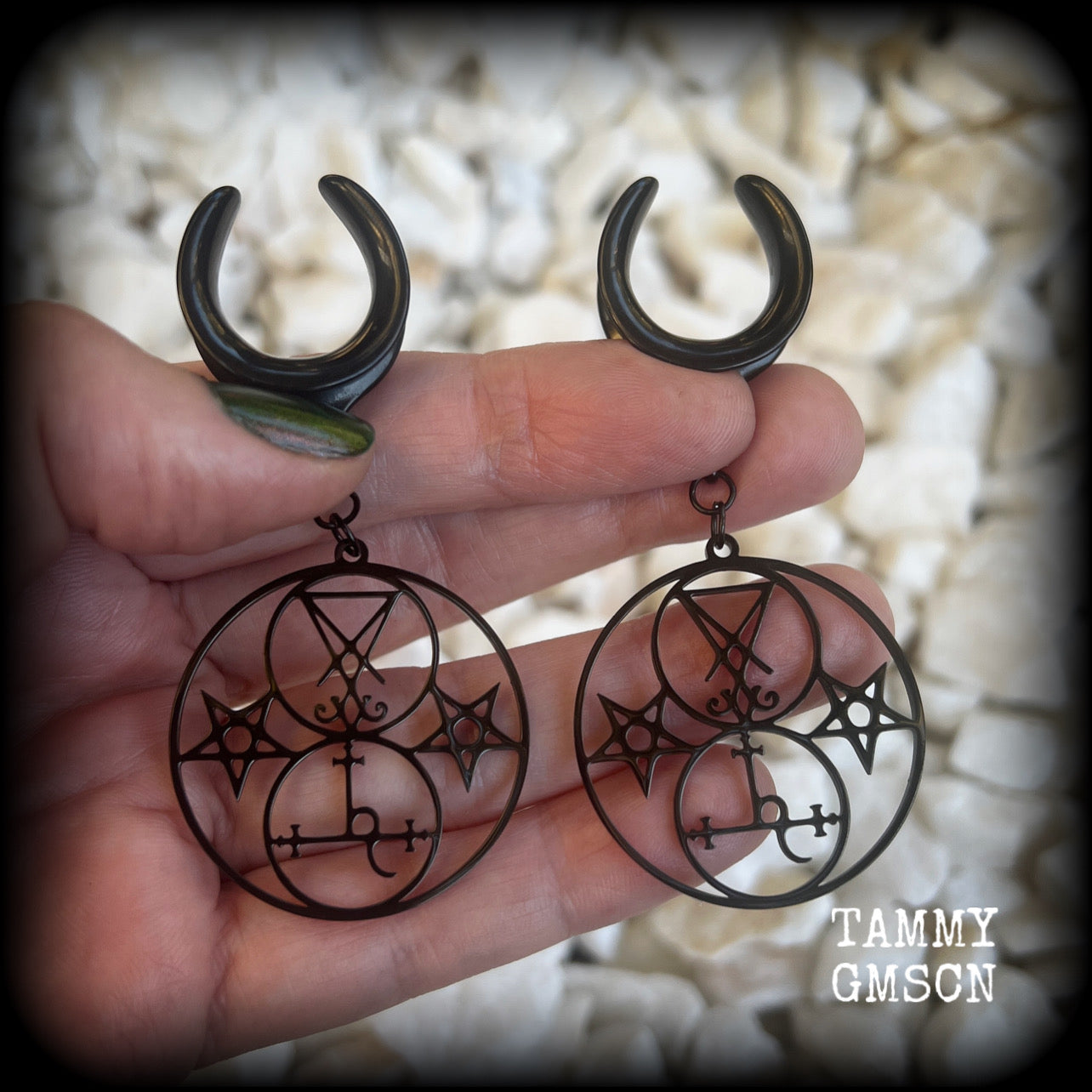 These gorgeous stainless steel earrings feature the Sigil of Lilith with the Sigil of Lucifer flanked by inverted pentagrams on each side. These earrings are lovely and light weight, weighing approx 9 grams each, and measure just on 7.5 cms from tip to tip.

This pair has been made on 3/4” gauge (19mm) surgical steel cradle hooks, to be worn in stretched lobes.