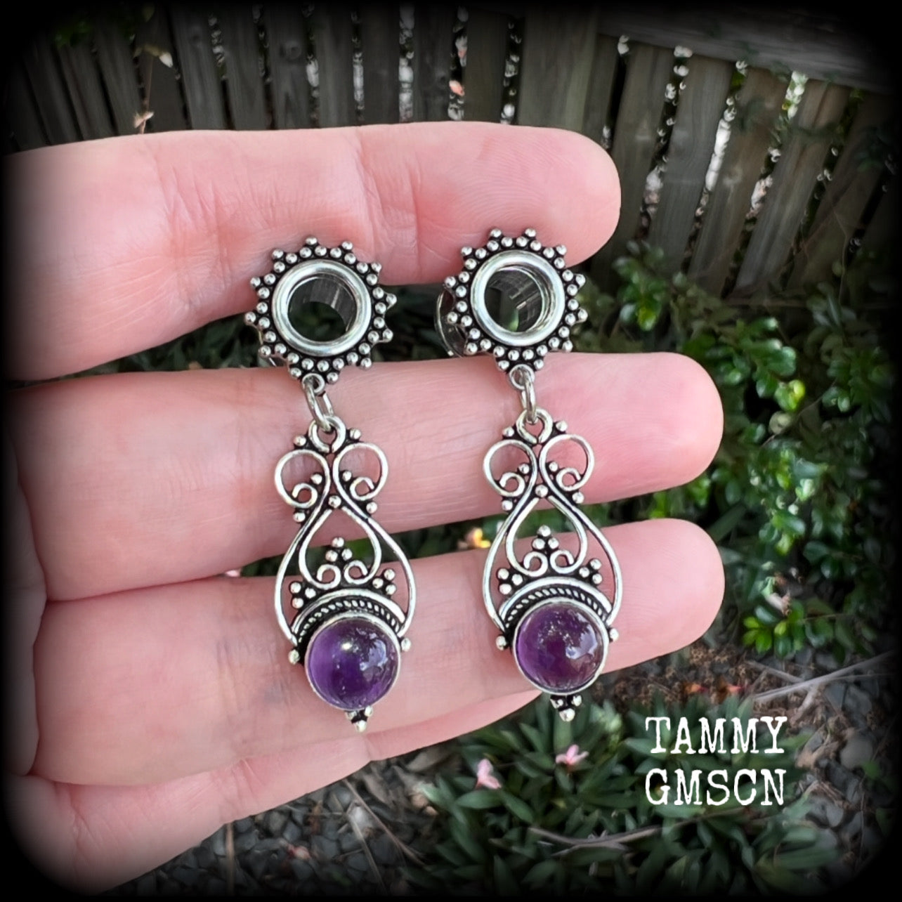 These beautiful boho tunnel earrings feature gorgeous polished amethyst gemstones, weighing approx 5 grams each and measure just under 5cms from tip to tip.

This pair has been made with 0 gauge (8mm) ornate surgical steel screw fit tunnels.
