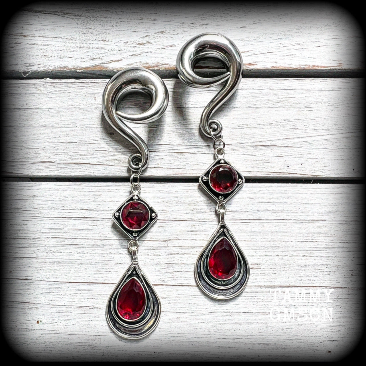 These beautiful dangly gauged earrings feature gorgeous deep red faceted garnet gemstones in an ornate antique silver setting, measuring just over 10cms from tip to tip, and weigh approx 27 grams each.

This pair have been made with 00 gauge (10mm) surgical steel full curl hooks, to be worn in stretched lobes.

