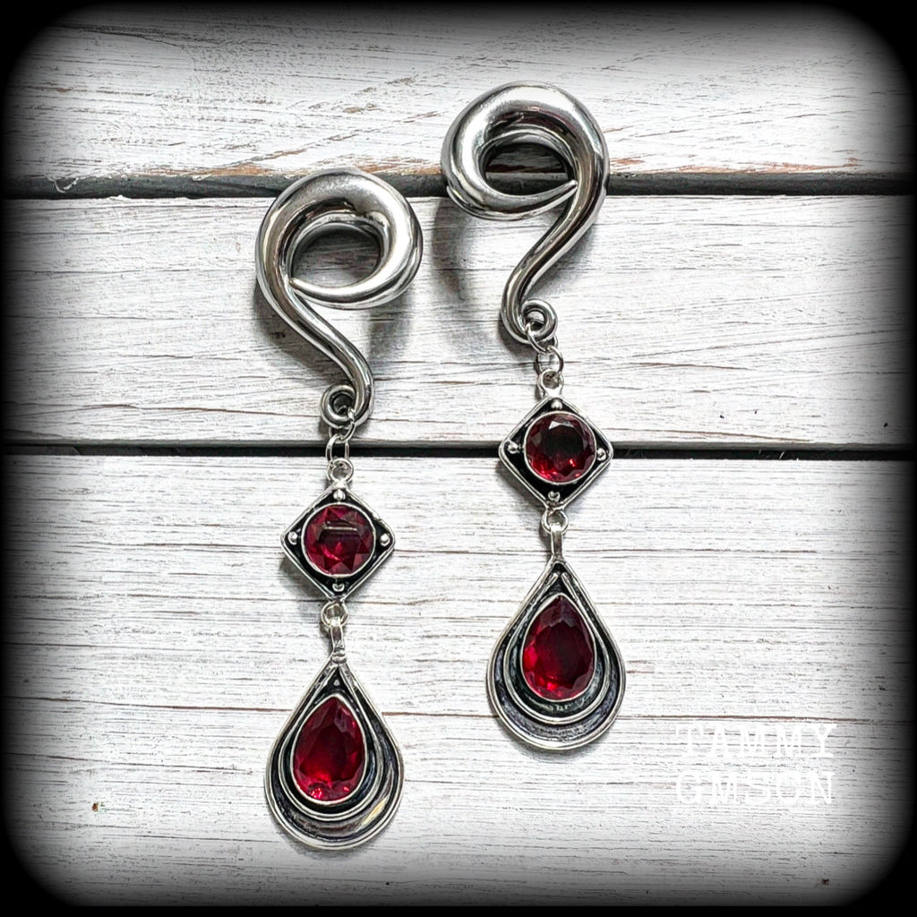 These beautiful dangly gauged earrings feature gorgeous deep red faceted garnet gemstones in an ornate antique silver setting, measuring just over 10cms from tip to tip, and weigh approx 27 grams each.

This pair have been made with 00 gauge (10mm) surgical steel full curl hooks, to be worn in stretched lobes.

