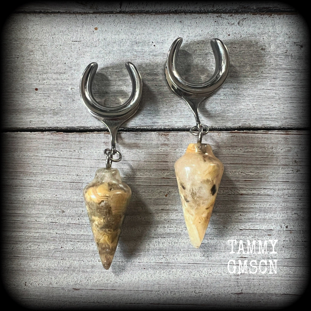 These light weight ear hangers feature gorgeous milky lace agate pendulums, weighing in at 10 grams a piece, and nice and dangly at just on 7cms from tip to tip.

This pair has been made on 5/8” gauge (16mm) surgical steel cradles, suitable for stretched lobes.

