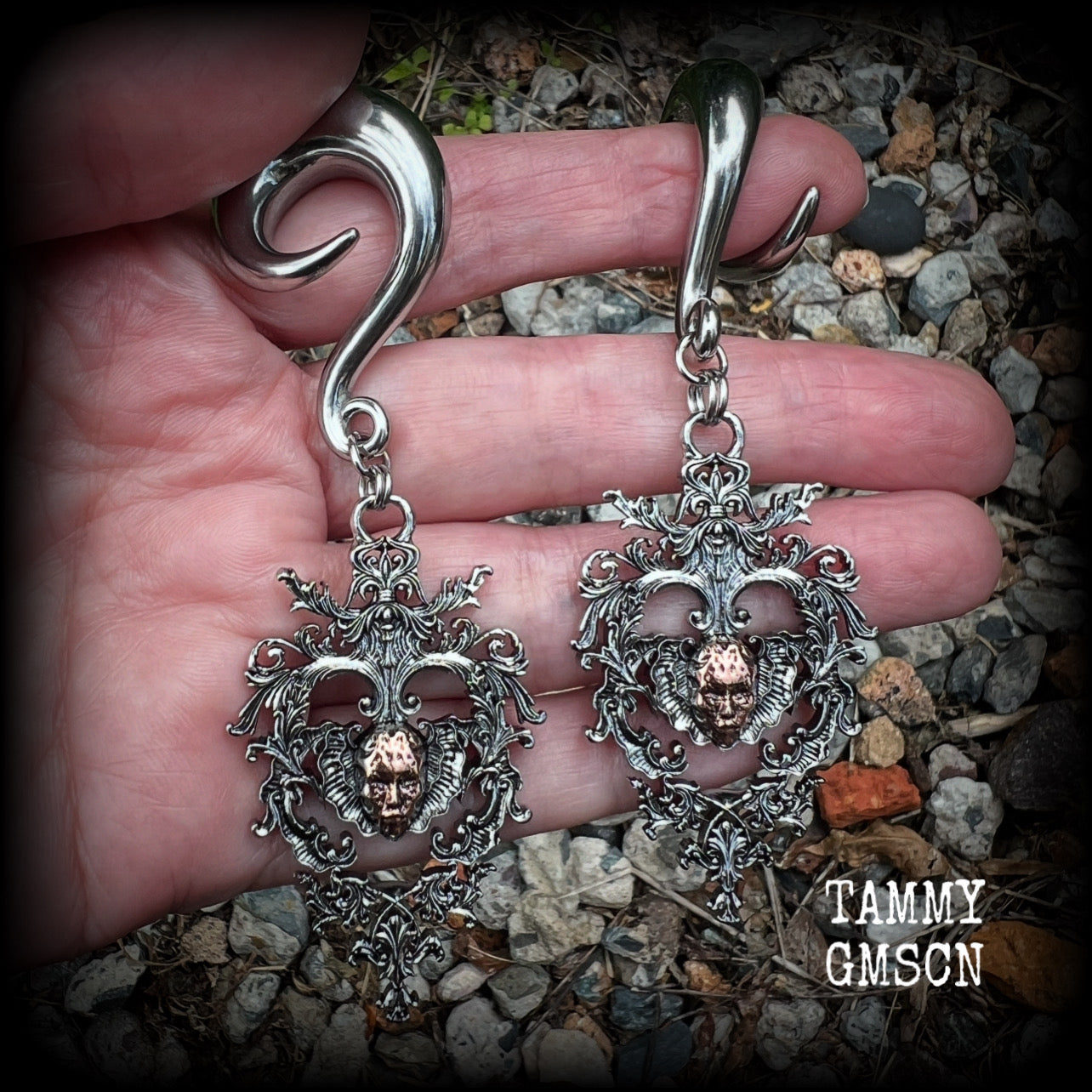 These gorgeous gauged earrings feature the face of a lost soul trapped within the bounds of beautiful baroque antique silver frames, measuring just under 9cms from tip to tip, and weighing approx 33 grams each.

This pair has been made on 00 gauge (10mm) surgical steel full curls, to be worn in stretched lobes.
