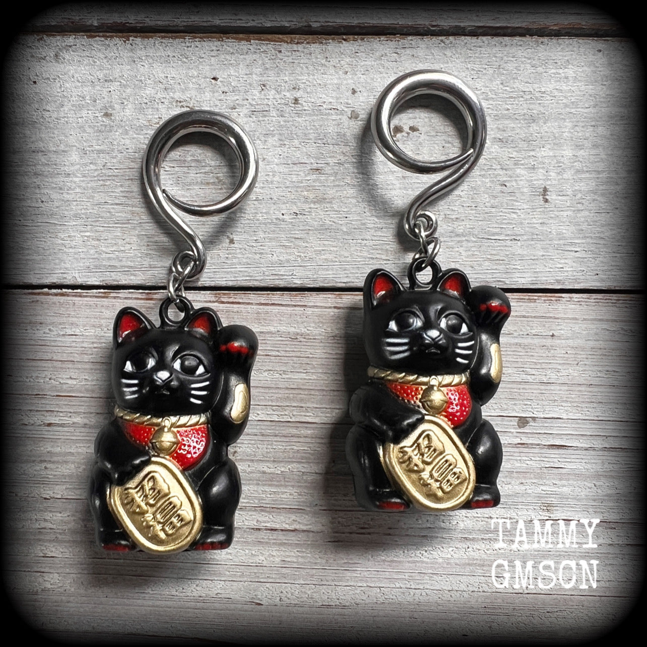 Black Japanese Maneki Neko beckoning cat ear weights for stretched lobes. Available on half curls, full curls and cradles from 4mm up to 30mm. This pair has been made on 6 gauge full curls, for stretched lobes.