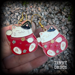 Featuring red and white maneki neko cat charms, theses earrings measure just under 5cms from tip to tip, and weigh only a few grams each.

This pair have been made with antique gold french hooks, suitable for pierced ears.