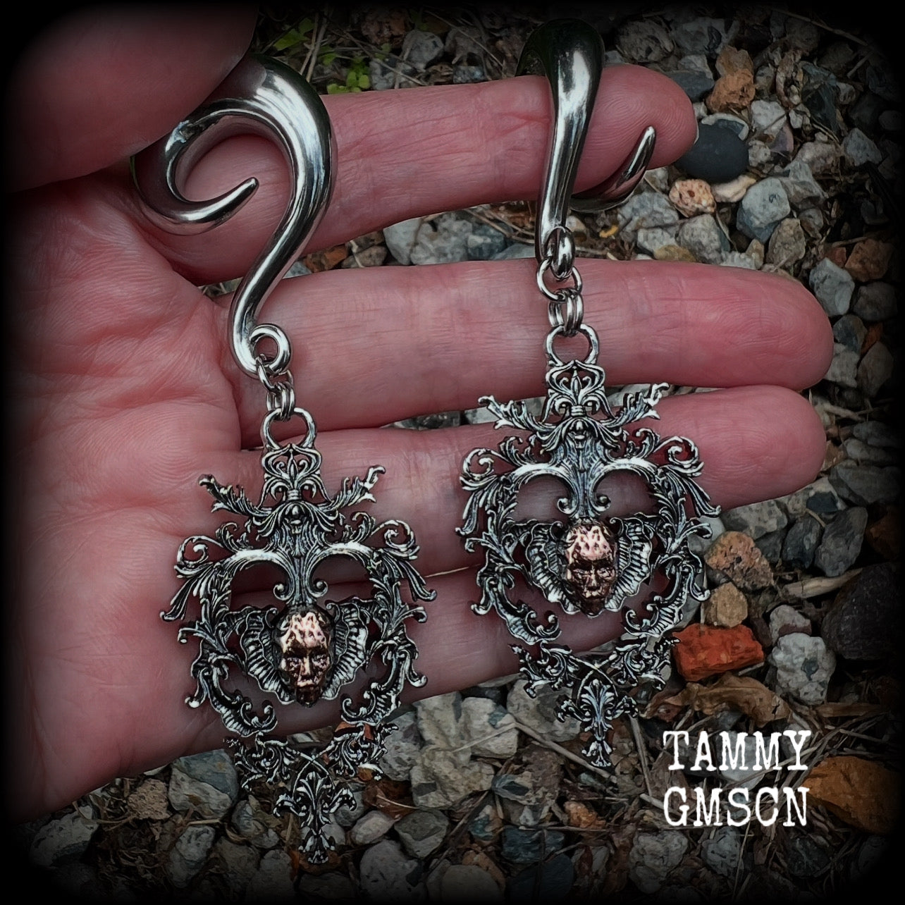 These gorgeous gauged earrings feature the face of a lost soul trapped within the bounds of beautiful baroque antique silver frames, measuring just under 9cms from tip to tip, and weighing approx 33 grams each.

This pair has been made on 00 gauge (10mm) surgical steel full curls, to be worn in stretched lobes.