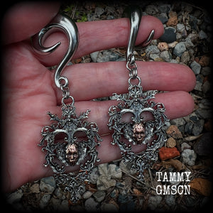 These gorgeous gauged earrings feature the face of a lost soul trapped within the bounds of beautiful baroque antique silver frames, measuring just under 9cms from tip to tip, and weighing approx 33 grams each.

This pair has been made on 00 gauge (10mm) surgical steel full curls, to be worn in stretched lobes.