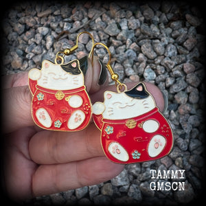 Featuring red and white maneki neko cat charms, theses earrings measure just under 5cms from tip to tip, and weigh only a few grams each.

This pair have been made with antique gold french hooks, suitable for pierced ears.