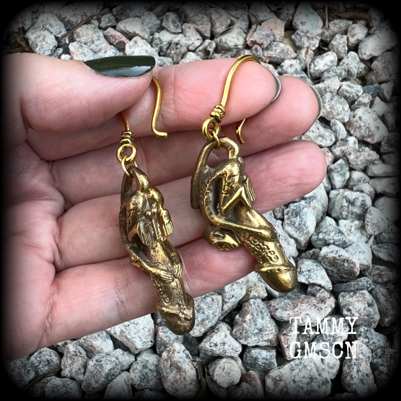 Featuring a brass Paladkhik penis charm, worn to attract love sex wealth and success and to protect from evil, these unique earrings weigh 19 grams each and measure just over 6cms from tip to tip.

This pair have been made on small antique antique gold shephard hooks, to be worn through stretched ears with silicone earlets from 8 gauge (3mm).