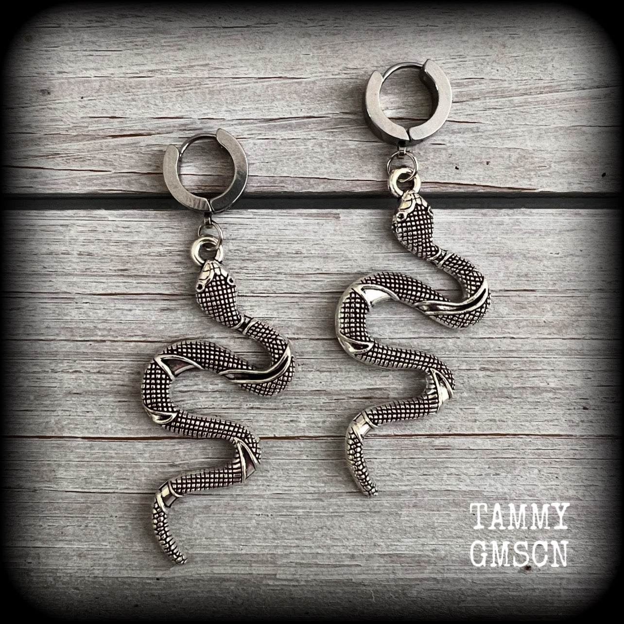 These awesome earrings feature an antique silver snake, are nice and lightweight at 7 grams each, and measure in at approx 7cms from tip to tip.

This pair have been made on stainless steel huggie ear cuffs, suitable for pierced ears.
