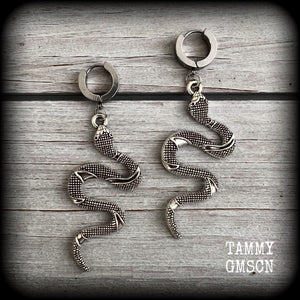 These awesome earrings feature an antique silver snake, are nice and lightweight at 7 grams each, and measure in at approx 7cms from tip to tip.

This pair have been made on stainless steel huggie ear cuffs, suitable for pierced ears.