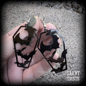 These awesome earrings feature pitch black acrylic coffins filled with bats! These earrings measure just over 6 cms from tip to tip and are nice and lightweight at only a few grams each.

This pair have been made on stainless steel french hooks, to be worn in pierced ears.