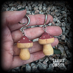 This pair of earrings features gorgeous dusty pink wood mushrooms, nice and light weight at 7 grams a piece, and nice and dangly at just on 6.5cms from tip to tip.

This pair has been made on 6 gauge (4mm) surgical steel full curl hooks, suitable for stretched lobes.