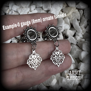 These beautiful ornate tunnel earrings feature gorgeous stainless steel filigree charms, inspired by Aphrodite, the Greek Goddess of love and beauty.

These earrings are nice and lightweight, weighing only a few grams each and measure just under 4cms from tip to tip.

This pair has been made with 0 gauge (8mm) gauge ornate surgical steel screw fit tunnels.