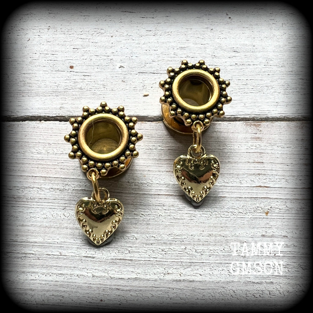 These stunning tunnel earrings feature gorgeous antique gold heart charms, and are nice and lightweight, weighing only a few grams each, measuring just under 4cms from tip to tip.

This pair has been made on 0 gauge (8mm) ornate surgy steel screw fit tunnels-for stretched lobes.