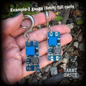 These awesome earrings feature pieces of blue circuitry, are nice and dangly, measuring just on 7cms from tip to tip, and nice and light weight, weighing approx 12 grams each.

This pair has been made on 2 gauge (6mm) surgical steel full curl hooks, to be worn in stretched lobes.
