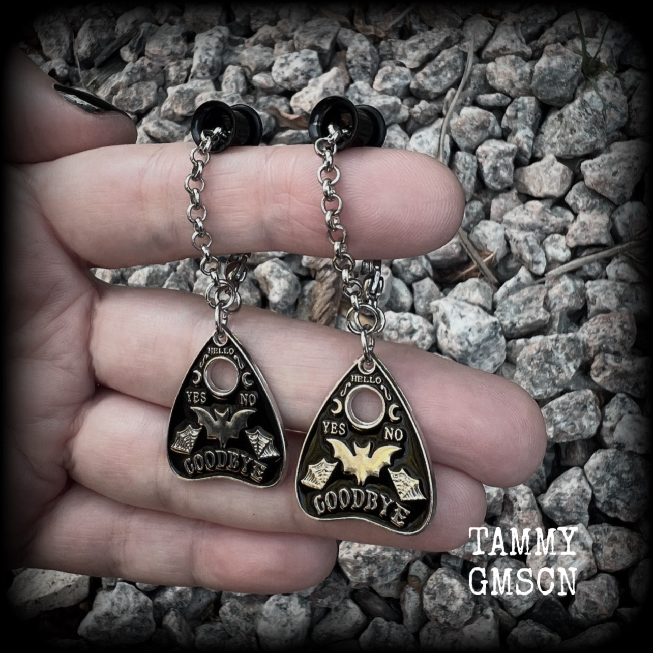 These beautiful antique silver and black enamel tunnel dangles are nice and lightweight and nice and dangly, weighing only 4 grams each, and measuring just over 6cms from tip to tip.

🕷️ PLEASE NOTE-This particular chain will not fit through tunnels smaller than 4 gauge (5mm), though I have lots of different chains that will. Get in touch and we can pick something just for you x

💥This listing includes one pair of surgical steel single flared O-ring earlets. 
