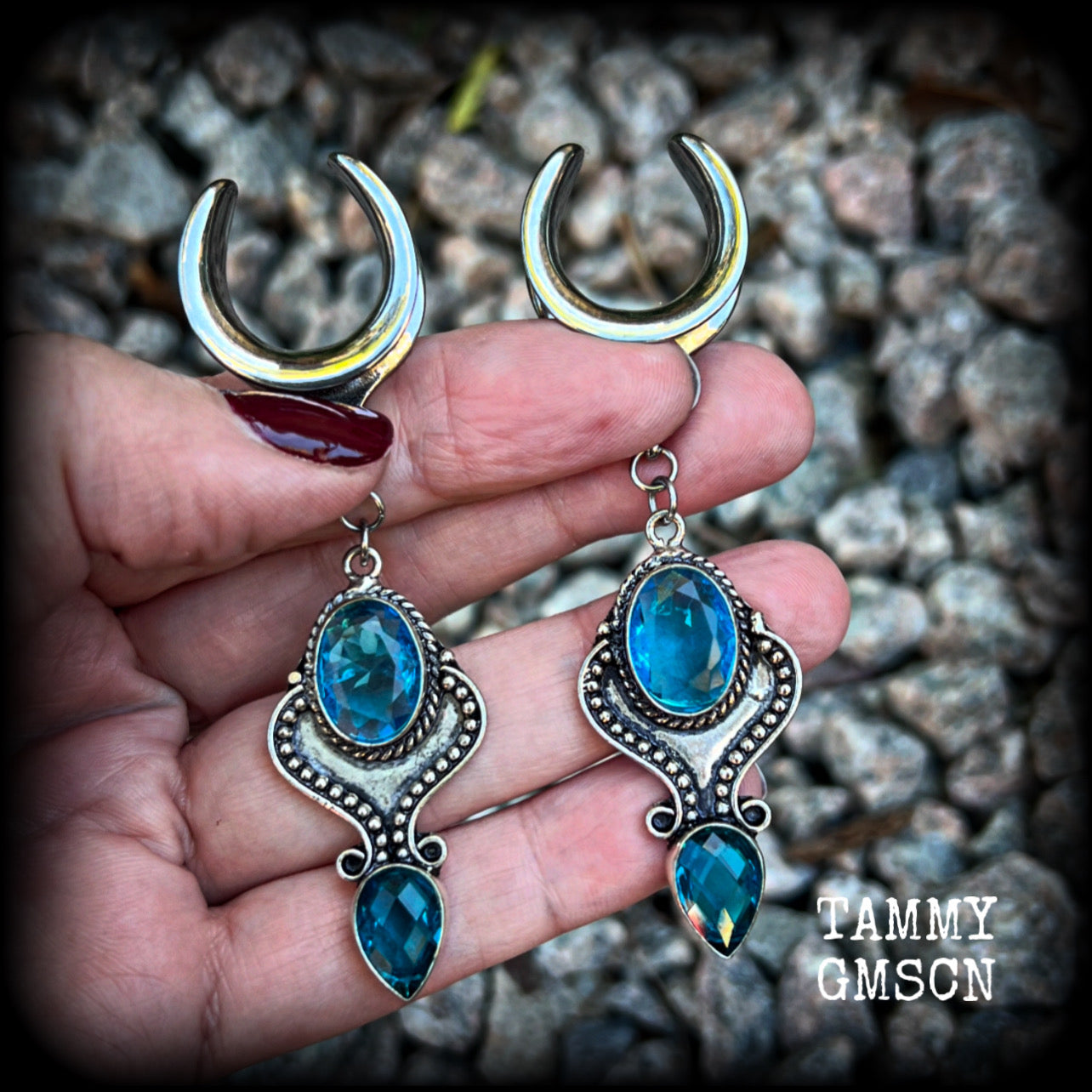 These earrings feature gorgeous facet blue topaz gemstones in a beautiful boho antique silver setting, lovely and dangly at just on 8cms from tip to tip, and not too heavy at 12 grams each.

These earrings have been made on 3/4” gauge (19mm) surgical steel cradles, to be worn in stretched lobes.