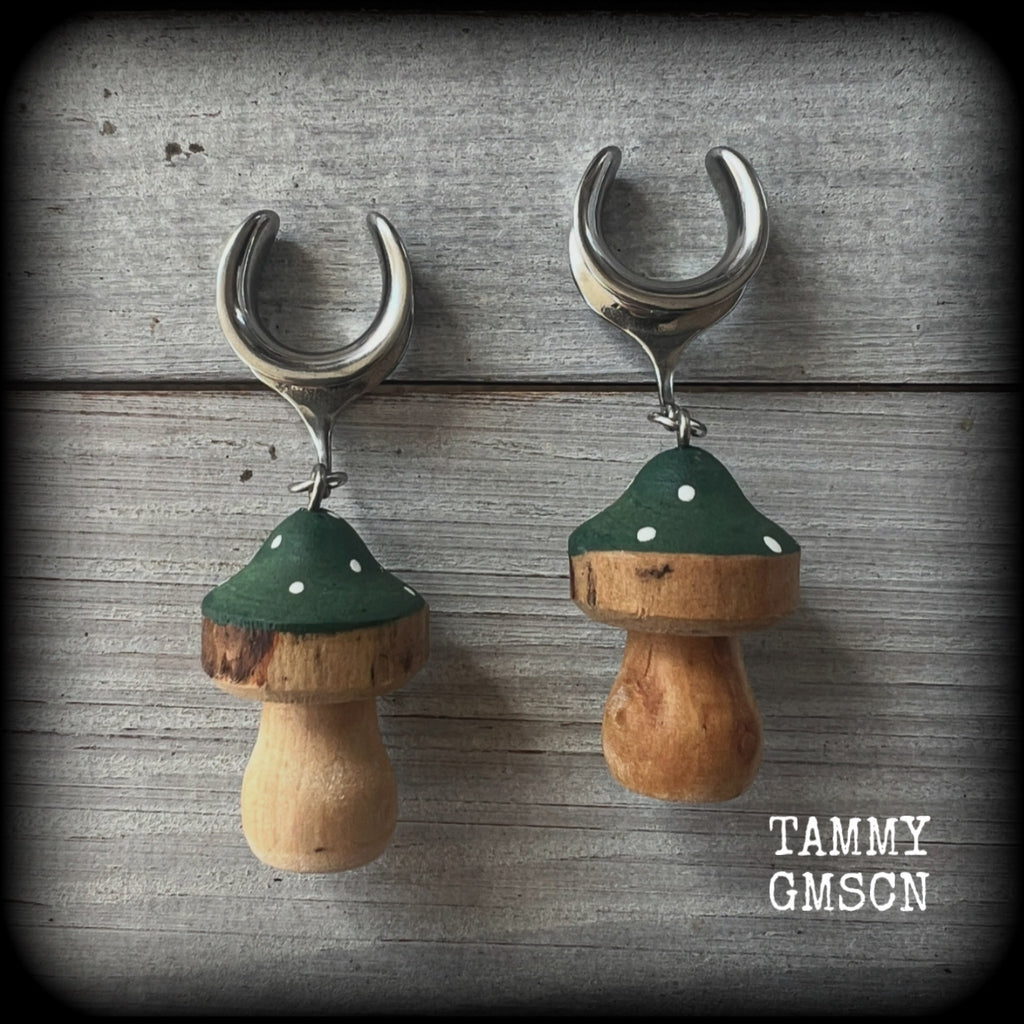 This pair of earrings features gorgeous forest green wood mushrooms, nice and light weight at 8 grams a piece, and nice and dangly at just on 7cms.

This pair has been made on 5/8” gauge (16mm) surgical steel cradles, suitable for stretched lobes.

