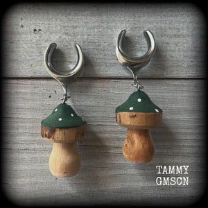 This pair of earrings features gorgeous forest green wood mushrooms, nice and light weight at 8 grams a piece, and nice and dangly at just on 7cms.

This pair has been made on 5/8” gauge (16mm) surgical steel cradles, suitable for stretched lobes.

