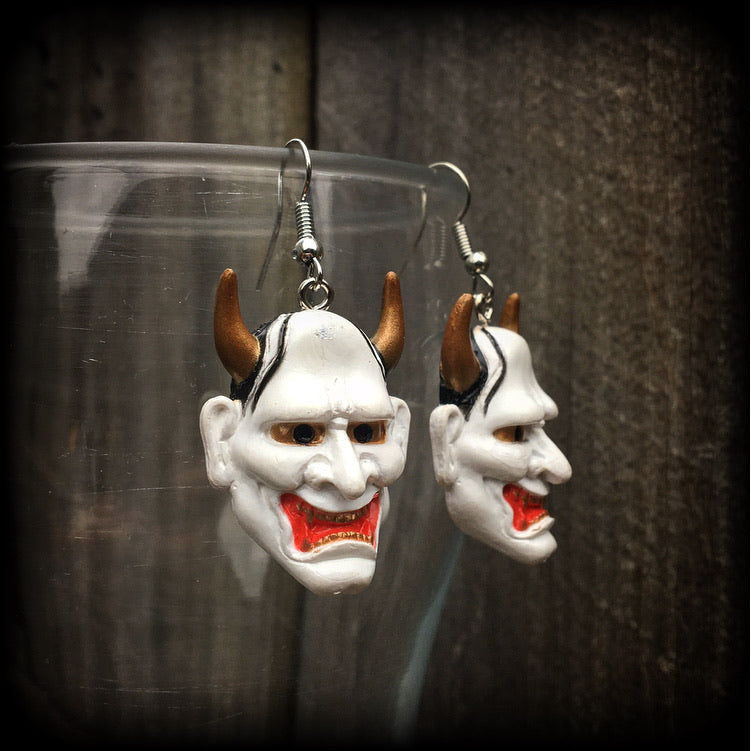 Featuring traditional red white and gold carved wood hannya mask charms, these unique earrings measure just on 6cms from tip to tip, and weigh only 5 grams each.

This pair have been made with stainless steel french hooks, for pierced ears.