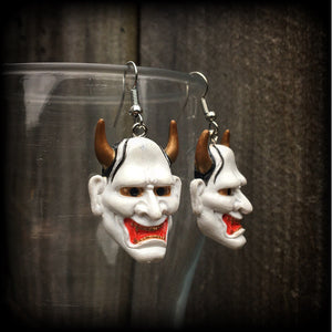 Featuring traditional red white and gold carved wood hannya mask charms, these unique earrings measure just on 6cms from tip to tip, and weigh only 5 grams each.

This pair have been made with stainless steel french hooks, for pierced ears.
