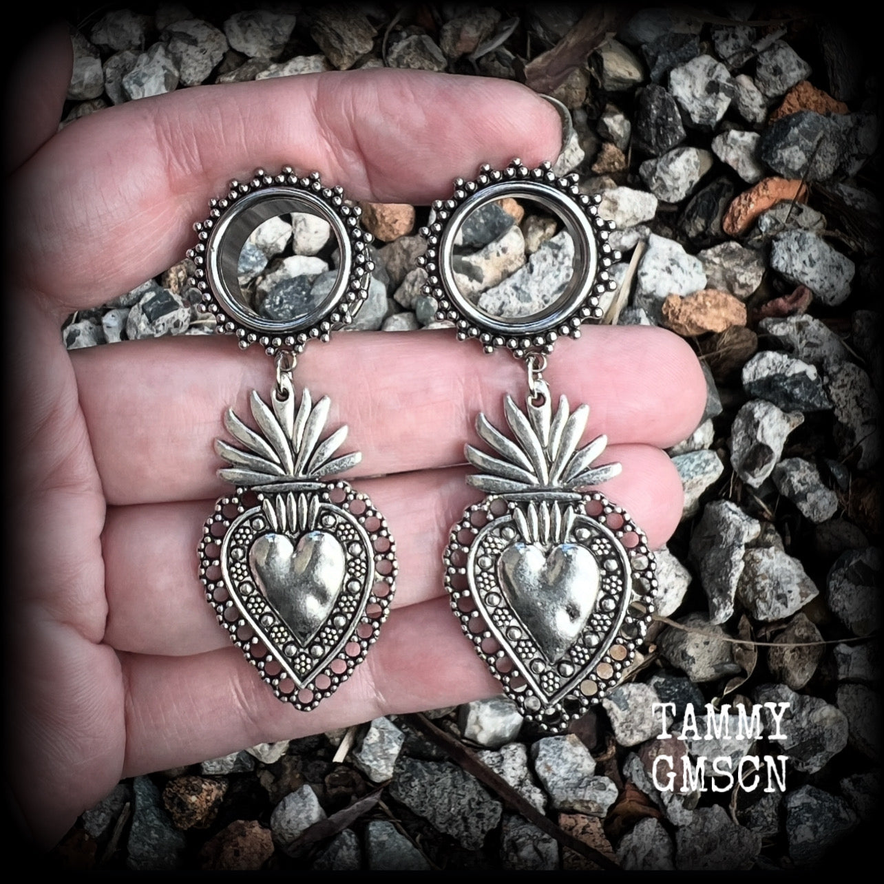 These gorgeous tunnel earrings feature beautiful antique silver sacred hearts, are nice and lightweight, weighing approx 10 grams each and measure just under 7cms from tip to tip.

This pair has been made with 9/16" (14mm) gauge ornate surgical steel screw fit tunnels.