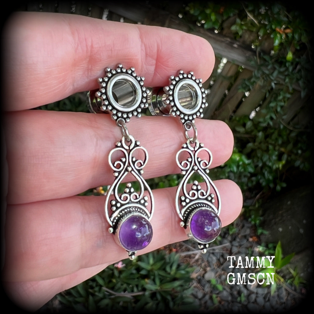 These beautiful boho tunnel earrings feature gorgeous polished amethyst gemstones, weighing approx 5 grams each and measure just under 5cms from tip to tip.

This pair has been made with 0 gauge (8mm) ornate surgical steel screw fit tunnels.
