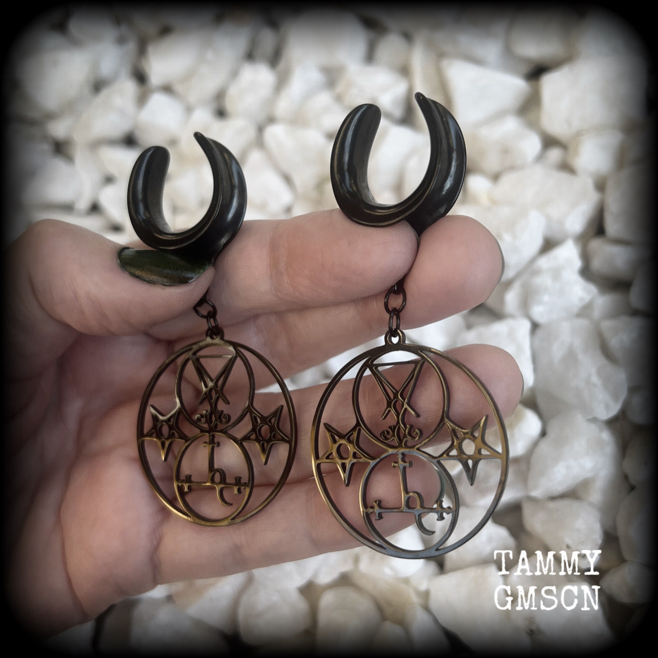 These gorgeous stainless steel earrings feature the Sigil of Lilith with the Sigil of Lucifer flanked by inverted pentagrams on each side. These earrings are lovely and light weight, weighing approx 9 grams each, and measure just on 7.5 cms from tip to tip.

This pair has been made on 3/4” gauge (19mm) surgical steel cradle hooks, to be worn in stretched lobes.