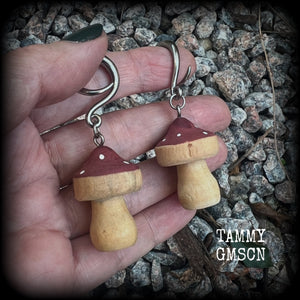 This pair of earrings features gorgeous dusty pink wood mushrooms, nice and light weight at 7 grams a piece, and nice and dangly at just on 6.5cms from tip to tip.

This pair has been made on 6 gauge (4mm) surgical steel full curl hooks, suitable for stretched lobes.