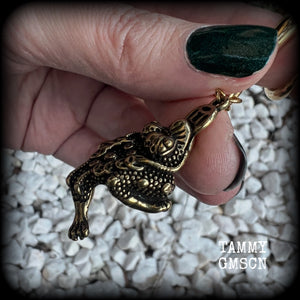 🔥 The three-legged golden toad is a mythological animal in China known to bring prosperity, treasure and wealth. To attract wealth, always have the money toads’ head facing you, and never away from you 🔥

These awesome brass ear hangers feature unique three legged brass money toads, measuring just on 7.5cms from tip to tip, and weighing approx 19 grams each.

This pair has been made on 2 gauge (6mm) titanium coated surgical steel full curls, suitable for stretched lobes.

