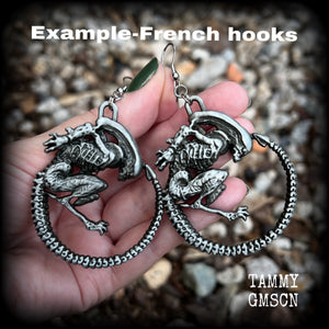 This pair of awesome earrings features large Alien Queen Xenomorphs, measuring 8.5cms from tip to tip (nice and big), and weigh 35 grams each (these are HEAVY).

This pair have been made with stainless steel french hooks-suitable for pierced ears.