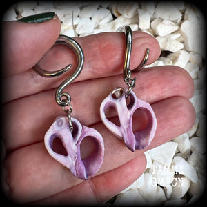 These gorgeous gauged earrings feature beautiful purple sea shell slices, weighing in approx 5 grams a piece, and measuring approx 5.5cms from tip to tip.

This pair has been made on 6 gauge (4mm) surgical steel full curl hooks, to be worn in stretched lobes.