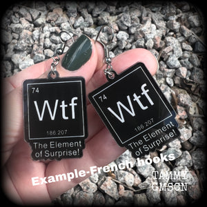 This cheeky pair of earrings features acrylic letter tiles showing the chemical element of Wtf, the Element of Surprise!!!
Measuring just over 6cms from tip to tip, these earrings weigh only a few grams each.

This pair has been made with stainless steel french hooks, suitable for pierced ears.