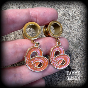 These adorable tunnel earrings feature classic enamel and antique gold pretzel charms, weighing approx 5 grams each, and measuring just over 4 cms from tip to tip.

This pair has been made with 1/2” gauge (12mm) surgical steel screw fit tunnels, to be worn in stretched lobes.