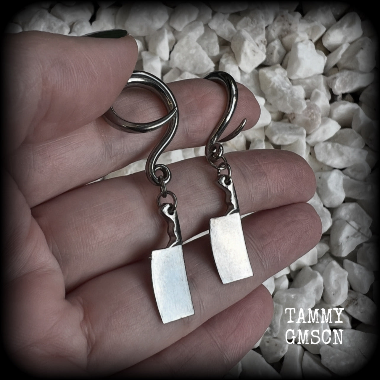 Featuring a pair of awesome antique silver meat cleavers, these earrings are super lightweight, weighing in at only 5 grams a piece, and are nice and dangly at just on 5.5cms.

🩸 Do you want a bit of b l o o d on your meat cleavers? Please just let us know!

This pair has been made on 6 gauge (4mm) surgical steel full curl hooks, to be worn in stretched lobes.