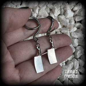 Featuring a pair of awesome antique silver meat cleavers, these earrings are super lightweight, weighing in at only 5 grams a piece, and are nice and dangly at just on 5.5cms.

🩸 Do you want a bit of b l o o d on your meat cleavers? Please just let us know!

This pair has been made on 6 gauge (4mm) surgical steel full curl hooks, to be worn in stretched lobes.