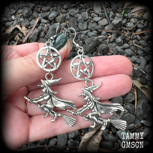 This pair of earrings feature a classic antique silver witch flying on her broomstick dangling from a silver pentagram, are nice and light weight at only 5 grams each, and nice and dangly, measuring just over 7cms from tip to tip.

This pair has been made on stainless steel french hooks, suitable for pierced ears.