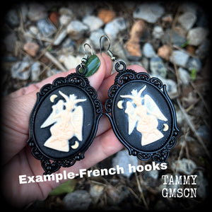 These gorgeous gothic earrings feature ivory Baphomets enclosed in beautiful black enamel framea, are light weight (11 grams a piece) and nice and dangly, measuring just over 8cms from tip to tip.

This pair has been made on stainless steel french hooks, suitable for pierced ears.

