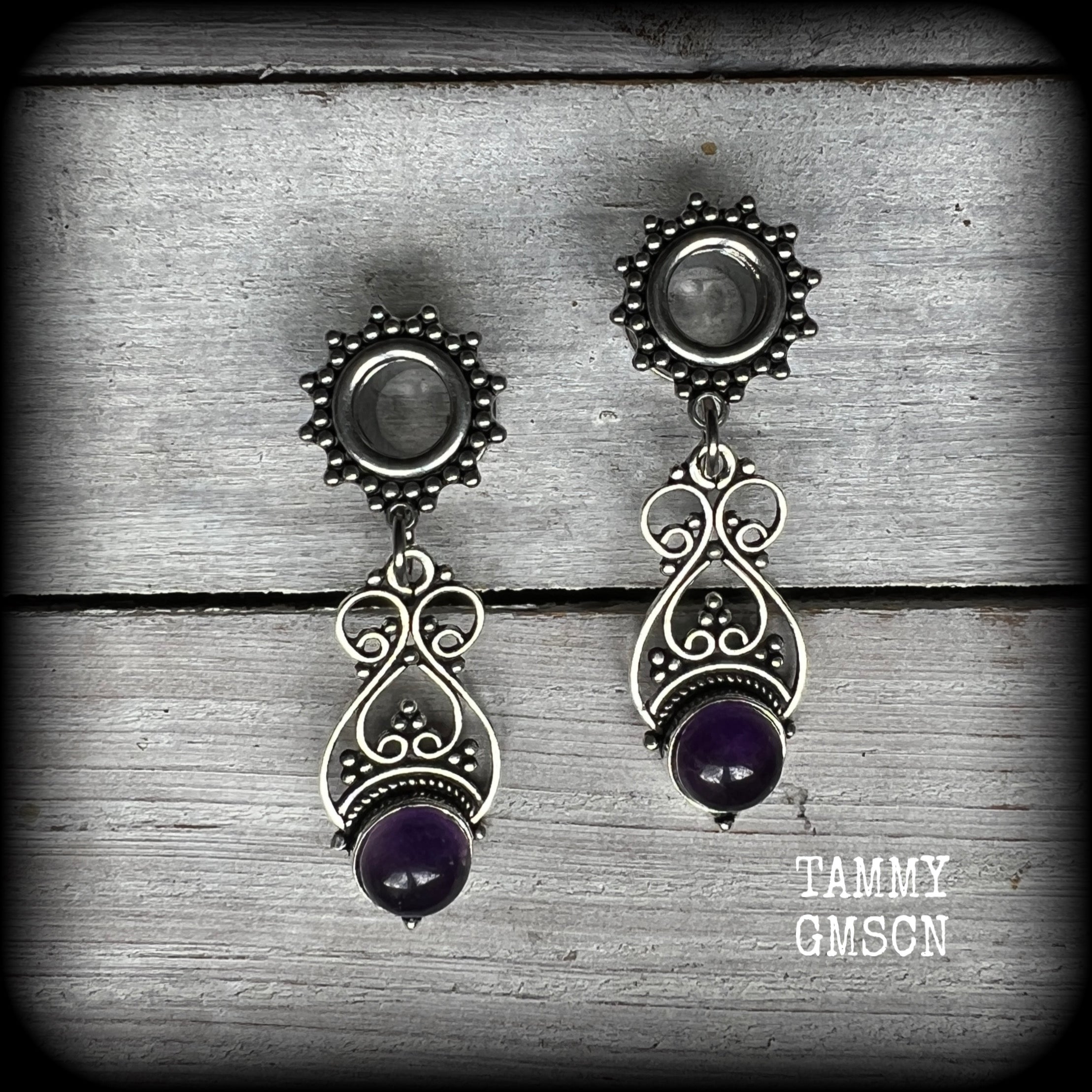 These beautiful boho tunnel earrings feature gorgeous polished amethyst gemstones, weighing approx 5 grams each and measure just under 5cms from tip to tip.

This pair has been made with 0 gauge (8mm) ornate surgical steel screw fit tunnels.
