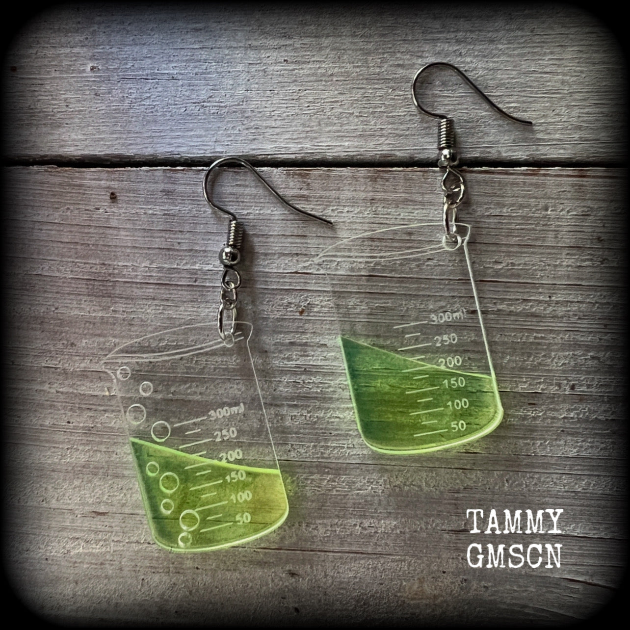 This pair of earrings features a pair of absolutely adorable classic Griffin chemistry beakers full of bubbly green liquid, measuring just under 6cms from tip to tip and weighing only a few grams each.

This pair have been made on stainless steel french hooks, suitable for pierced ears.