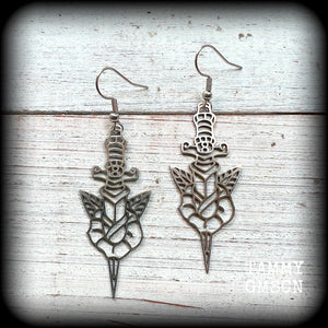 This pair of stainless steel earrings feature a classic punk rose and dagger tattoo design, measuring just on 6.5cms from tip to tip, and weighing only a grams or two each.

This pair has been made on stainless steel french hooks, suitable for pierced ears.