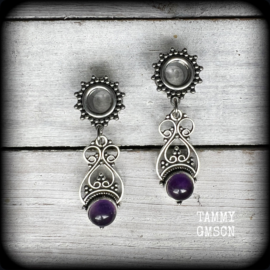 These beautiful boho tunnel earrings feature gorgeous polished amethyst gemstones, weighing approx 5 grams each and measure just under 5cms from tip to tip.

This pair has been made with 0 gauge (8mm) ornate surgical steel screw fit tunnels.
