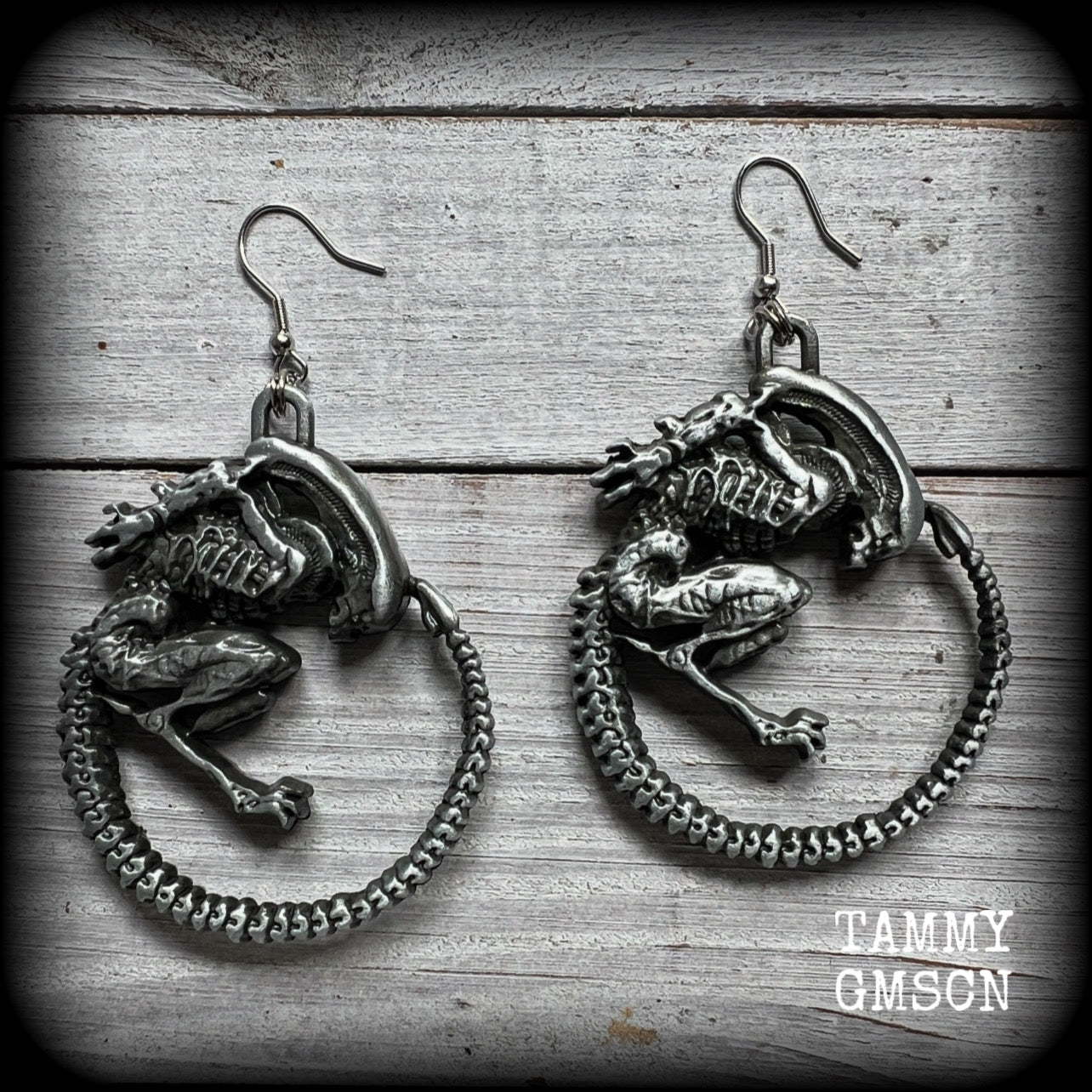 This pair of awesome earrings features large Alien Queen Xenomorphs, measuring 8.5cms from tip to tip (nice and big), and weigh 35 grams each (these are HEAVY).

This pair have been made with stainless steel french hooks-suitable for pierced ears.