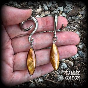 These gorgeous gauged earrings feature beautiful polished sea shell slivers, weighing in approx 10 grams a piece, and measuring approx 7cms from tip to tip.
This pair has been made on 2 gauge (6mm) surgical steel full curl hooks, to be worn in stretched lobes.