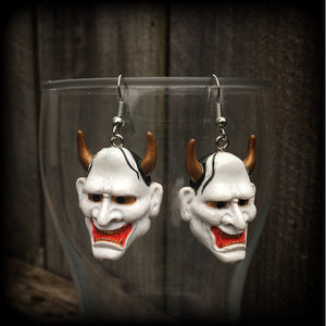 Featuring traditional red white and gold carved wood hannya mask charms, these unique earrings measure just on 6cms from tip to tip, and weigh only 5 grams each.

This pair have been made with stainless steel french hooks, for pierced ears.