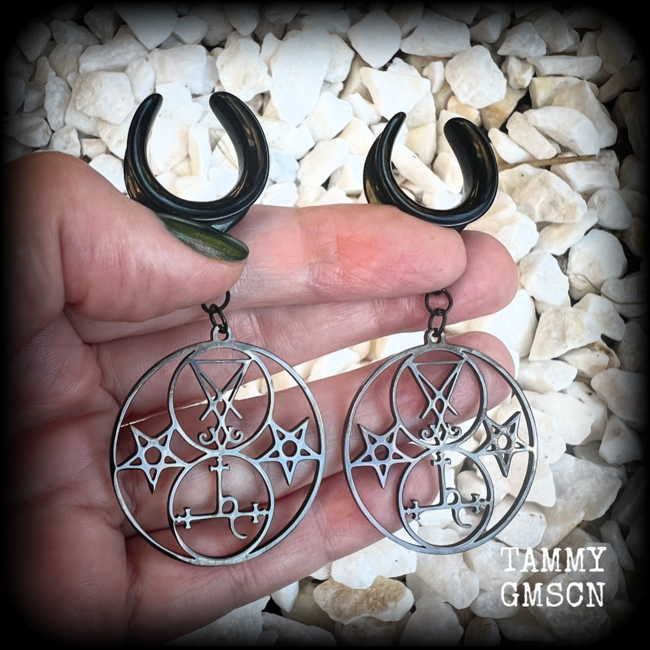 These gorgeous stainless steel earrings feature the Sigil of Lilith with the Sigil of Lucifer flanked by inverted pentagrams on each side. These earrings are lovely and light weight, weighing approx 9 grams each, and measure just on 7.5 cms from tip to tip.

This pair has been made on 3/4” gauge (19mm) surgical steel cradle hooks, to be worn in stretched lobes.