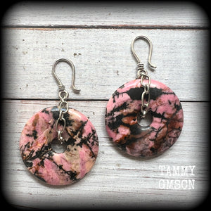 This is a pair of gorgeous ear hangers featuring dusty pink and chocolate brown Rhodonite gemstone donuts cradled in antique silver chain, weighing approx 23grams a piece, and measuring just under 7 cms from tip to tip.

This pair has made with small antique silver shephards hooks, to be worn with silicone earlets in stretched lobes from 8gauge (3mm).
